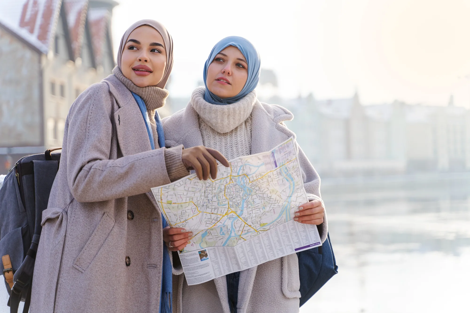 Muslim travelers checking a map while sightseeing during a Halal-friendly holiday tour in India.