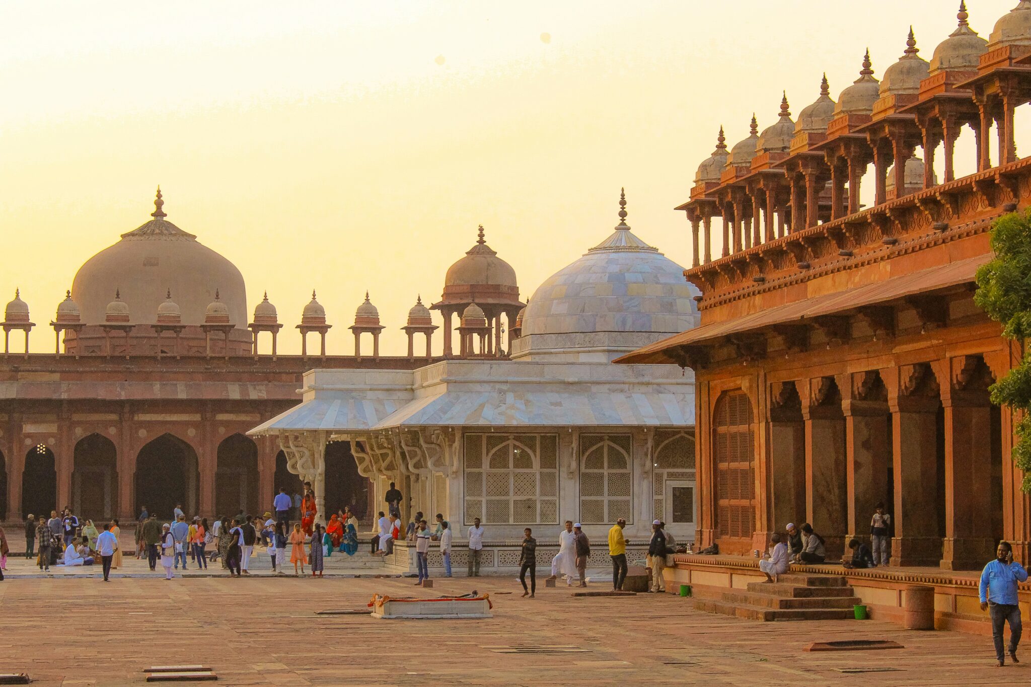 A group of Muslim travelers at the Dargah of Hazrat Sheikh Salim Chishti in Fatehpur Sikri during an Islamic heritage tour in India.