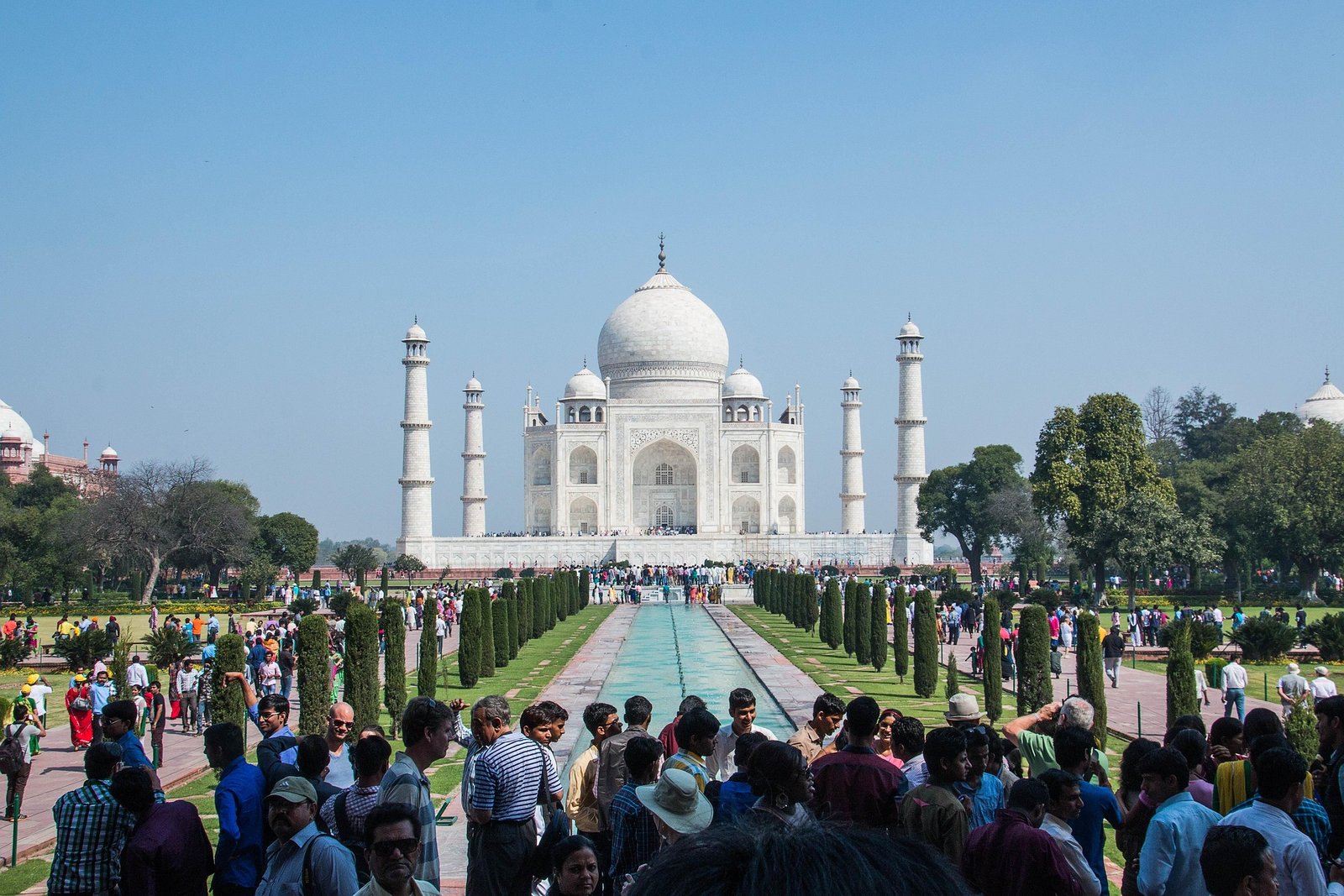 Muslim family admiring the majestic Taj Mahal at sunrise during a 7-day Halal tour of India.