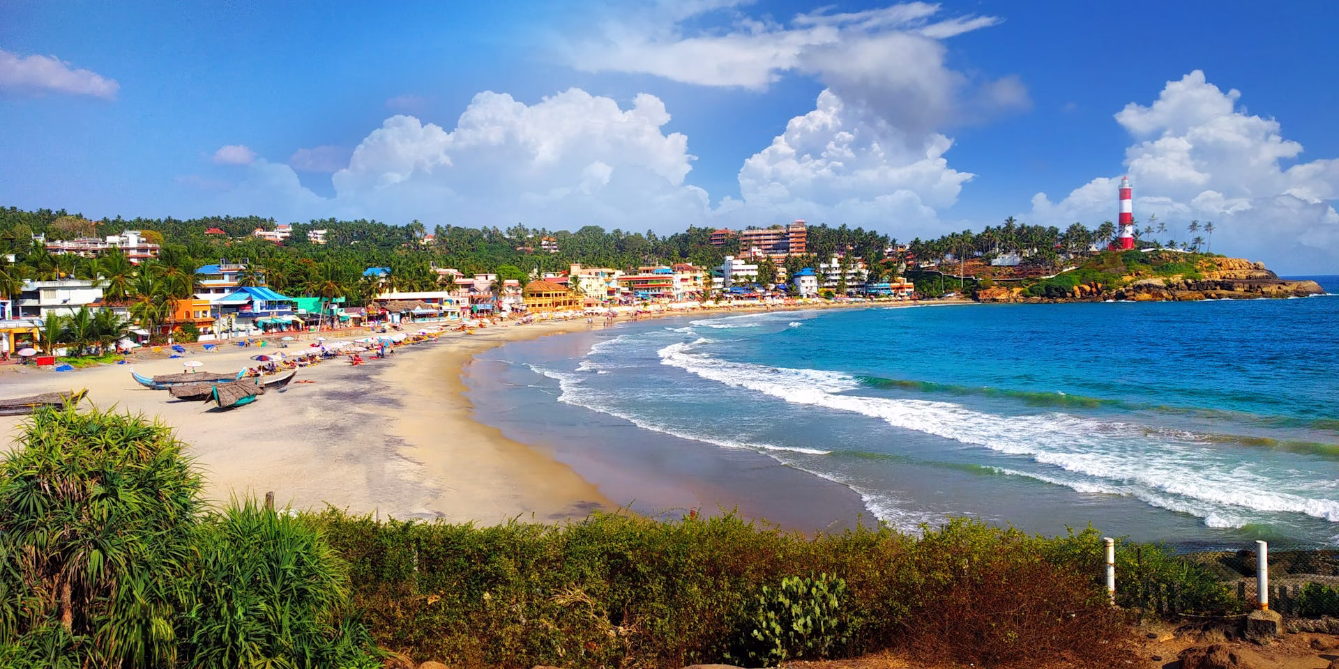 Panoramic view of Kovalam Beach in Kerala, a popular destination for a halal holiday.