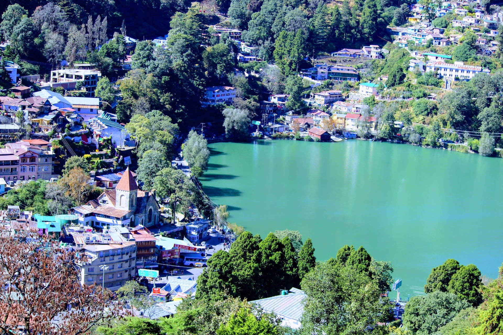 Boating on peaceful Naini Lake in Nainital with hillside views