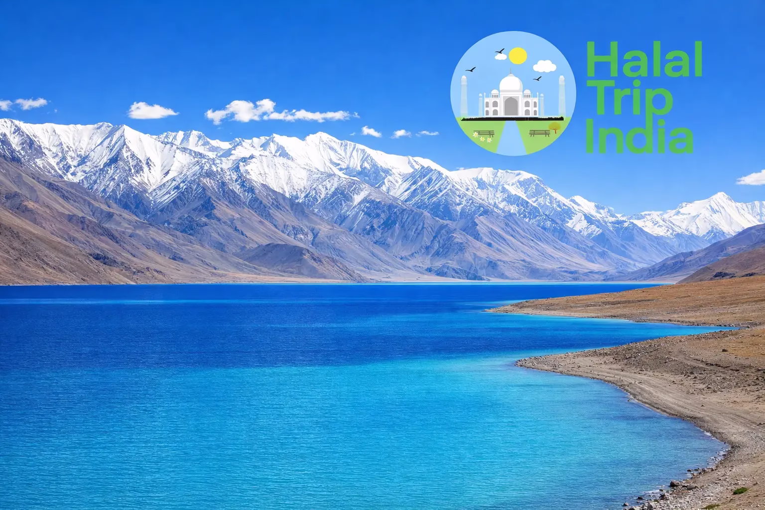 Breathtaking view of Pangong Lake's turquoise blue water against a backdrop of snow-capped Himalayan mountains in Ladakh, a top destination for Muslim family holidays in India.
