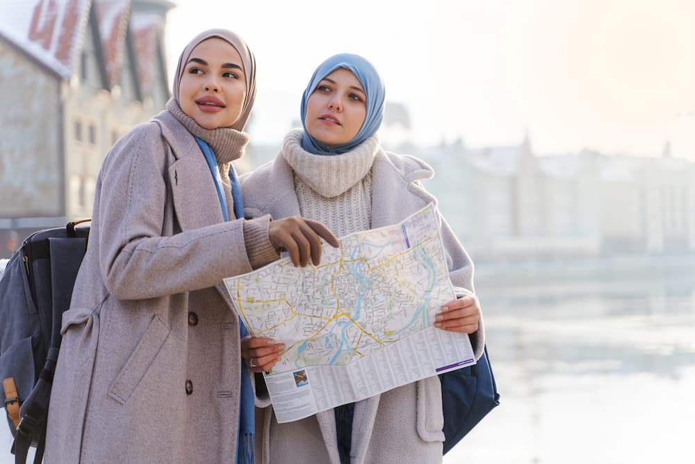 Muslim travelers checking a map while sightseeing on a Halal-friendly holiday in India