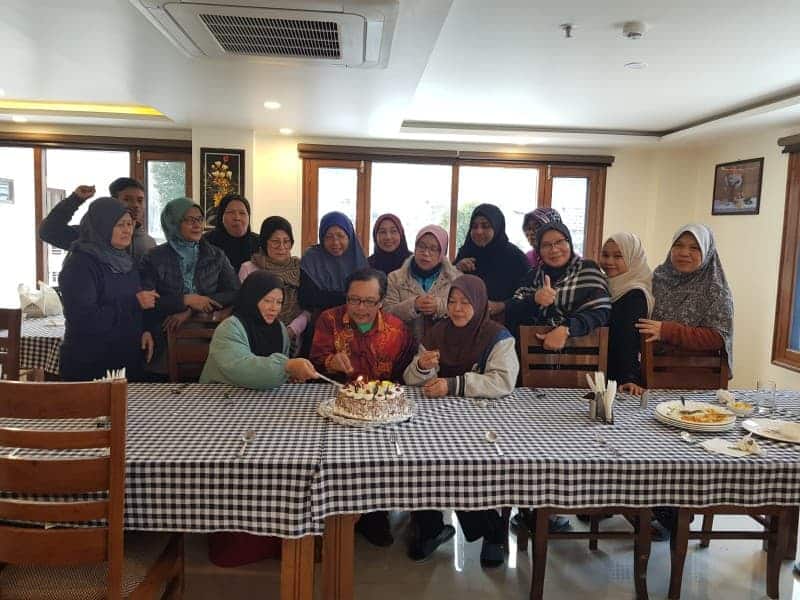 Muslim family enjoying a meal at a Halal-certified restaurant during their India travel