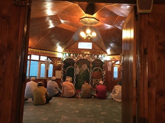 Muslim travelers offering prayers at a mosque during their Halal-friendly Himachal trip