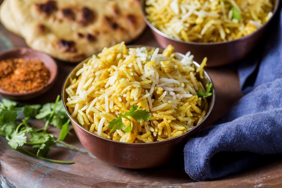 Muslim family enjoying traditional Kerala Halal food including biryani and pathiri