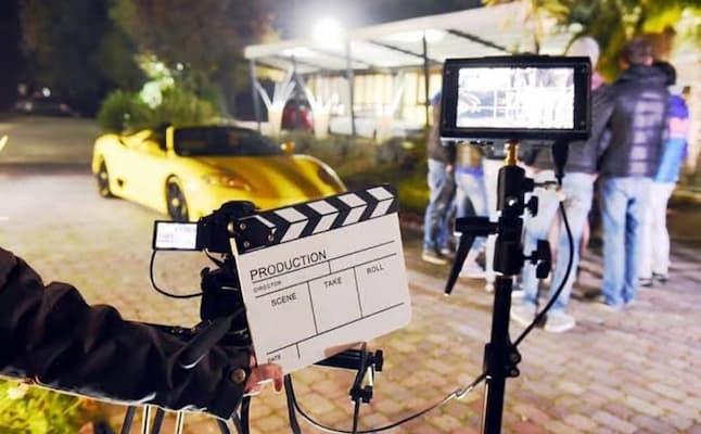 Muslim family watching a live film set being prepared during a Bollywood studio tour in Mumbai
