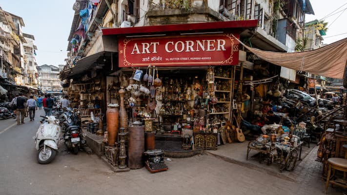Muslim family browsing antiques and curiosities at Chor Bazaar, Mumbai's historic flea market