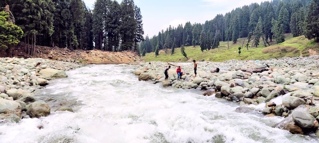 Muslim family picnicking in Doodhpathri's misty green meadows near Srinagar