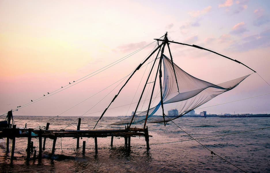 Muslim family exploring Fort Kochi's iconic Chinese fishing nets on a Halal-friendly tour