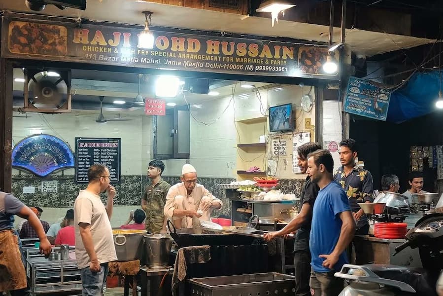 Muslim travelers enjoying halal kebab and biryani in Old Delhi during a Halal-friendly trip to India