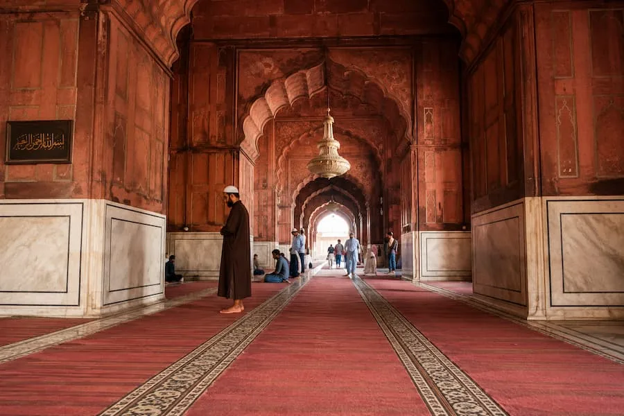 Muslim travelers offering namaz in the courtyard of Jama Masjid, Delhi's most prominent prayer facility