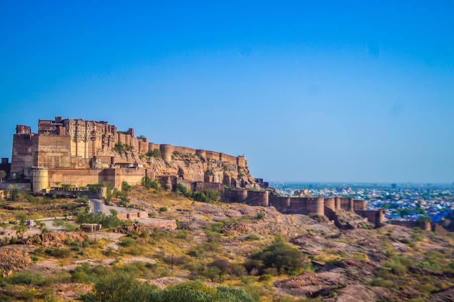 Aerial view of Jodhpur's Blue City houses with Mehrangarh Fort in the background