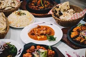 Muslim family enjoying traditional Kerala Halal food, including biryani and appam with stew