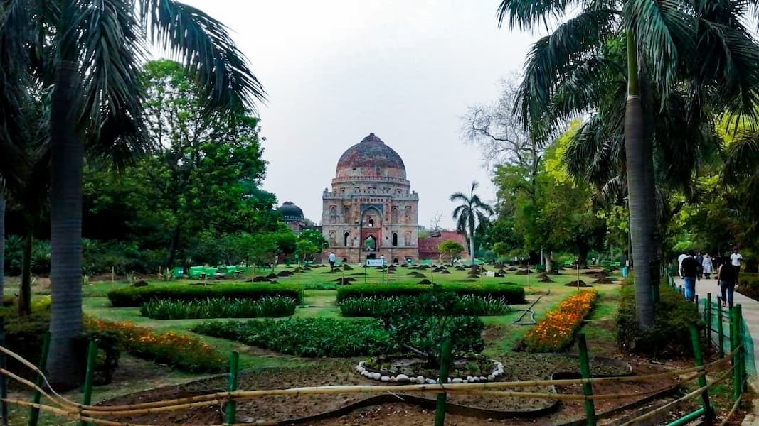 Muslim family enjoying a peaceful walk through Lodhi Garden's historic tombs and gardens