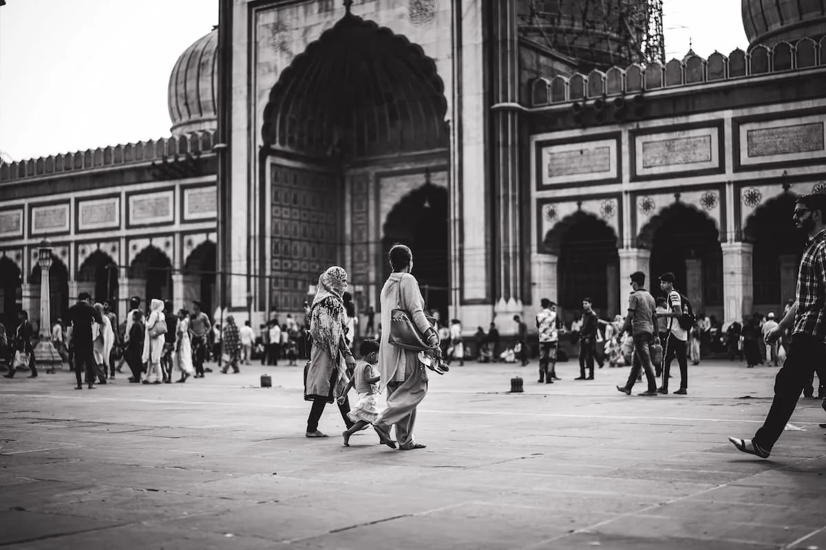 Muslim family exploring the historic Jama Masjid of Old Delhi's Shahjahanabad Mughal walled city on a Delhi Islamic heritage tour