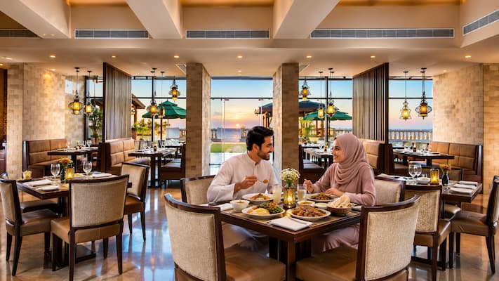 Muslim honeymoon couple dining at a halal restaurant during their romantic getaway in Mussoorie