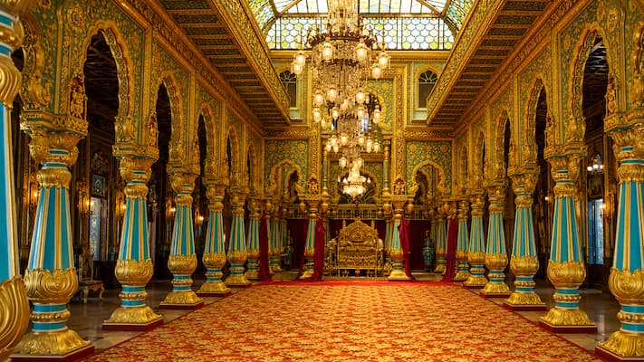 The intricate stained-glass ceilings and gold-leaf carvings inside Mysore Palace