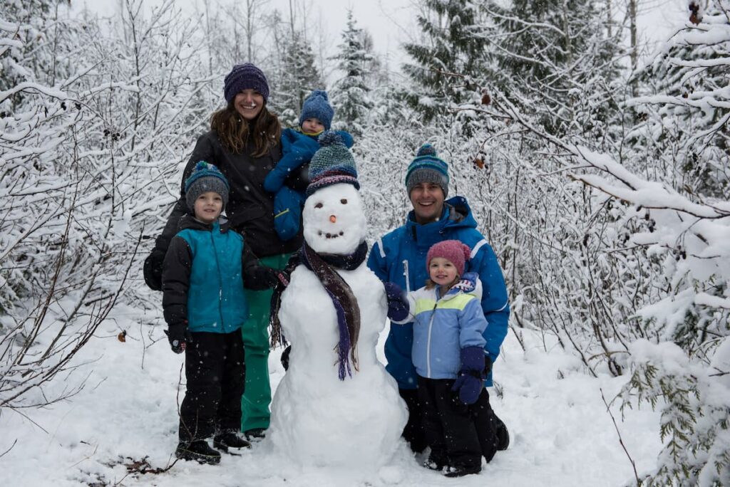 Muslim family enjoying snowfall together in Pahalgam, Kashmir