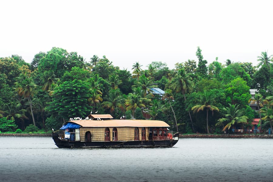 Muslim honeymoon couple enjoying a romantic houseboat stay in Poovar's backwaters near Kovalam