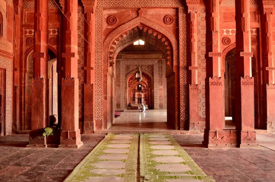 Muslim travelers offering prayers at a mosque during a Muslim-friendly trip to India