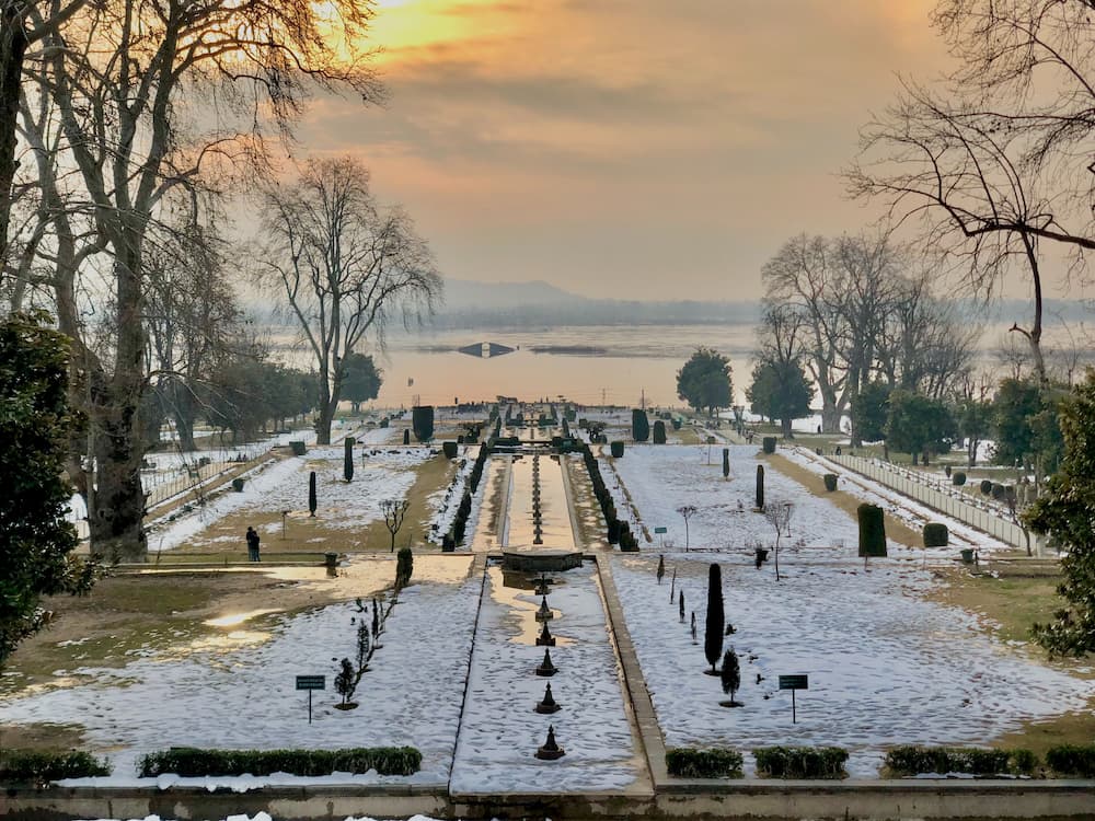 Family walking through terraced Mughal-era garden lawns