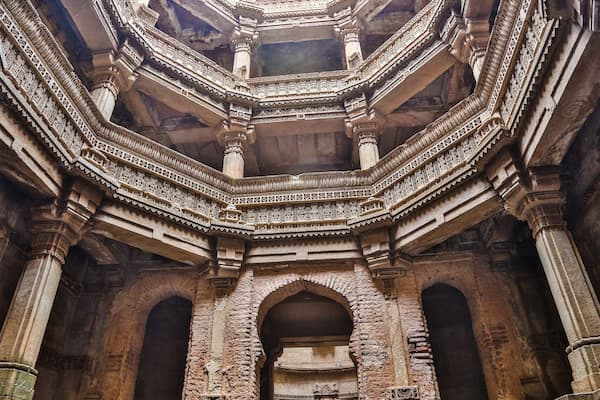Muslim family exploring Adalaj Stepwell's Indo-Islamic architecture near Ahmedabad