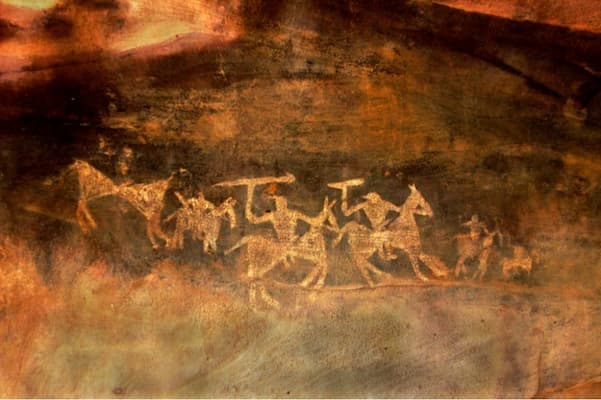 Muslim travelers exploring prehistoric rock art at the UNESCO-listed Bhimbetka Rock Shelters on this Bhopal Bhimbetka Halal Tour