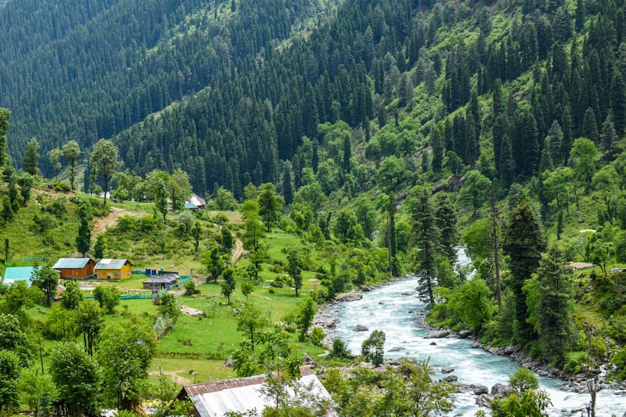 Muslim family picnicking in Doodhpathri's misty green meadows near Srinagar