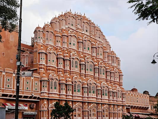 Hawa Mahal's honeycomb facade illuminated by morning light from the street below