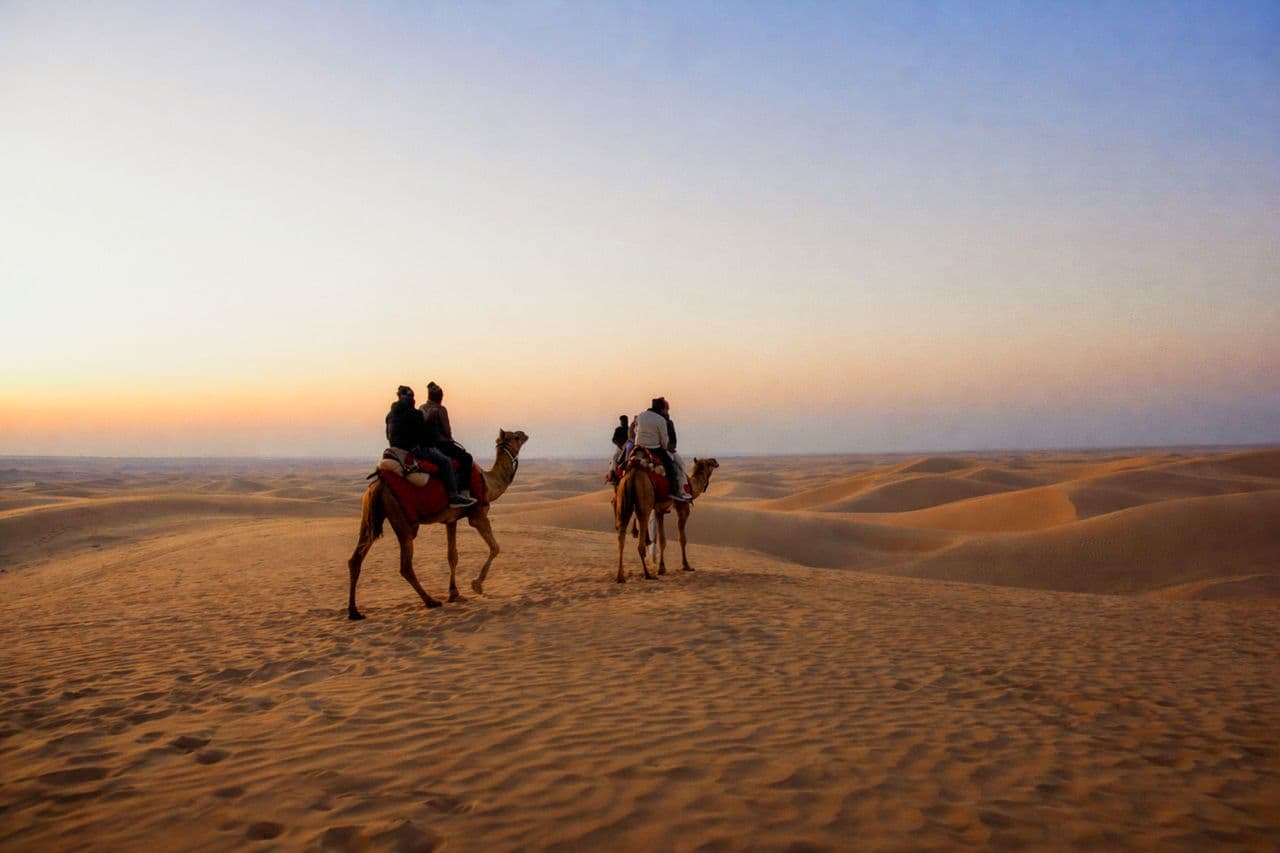 Muslim family enjoying a camel safari near Jaisalmer Fort on the Rajasthan 10-Day Halal Tour