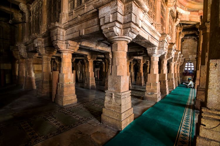 Muslim family admiring the interior columns of Jama Masjid, built by Sultan Ahmed Shah, in Ahmedabad