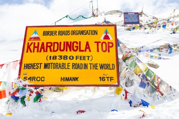Muslim family at Khardung La Pass, one of the world's highest motorable roads in Ladakh
