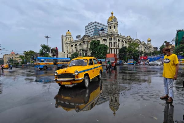 Muslim family riding one of Kolkata's iconic yellow taxis, a beloved symbol of the city's cultural identity