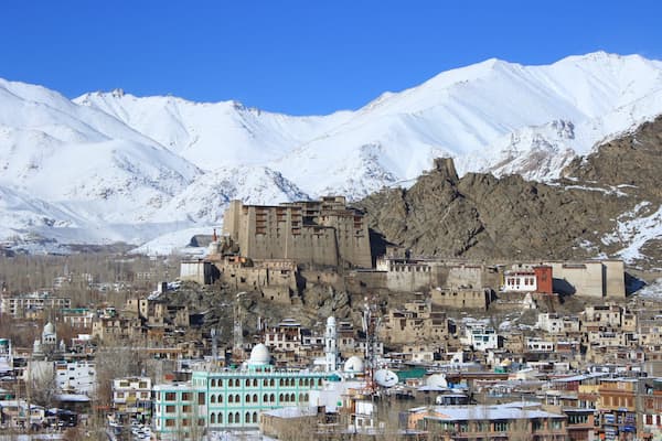 Muslim family exploring the 16th-century Leh Palace overlooking the city