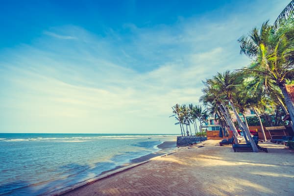 Muslim family enjoying a peaceful morning walk on Marari Beach during this 7-Day Kerala Halal Tour