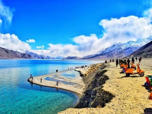 Muslim family at the turquoise waters of Pangong Lake, one of the world's highest lakes